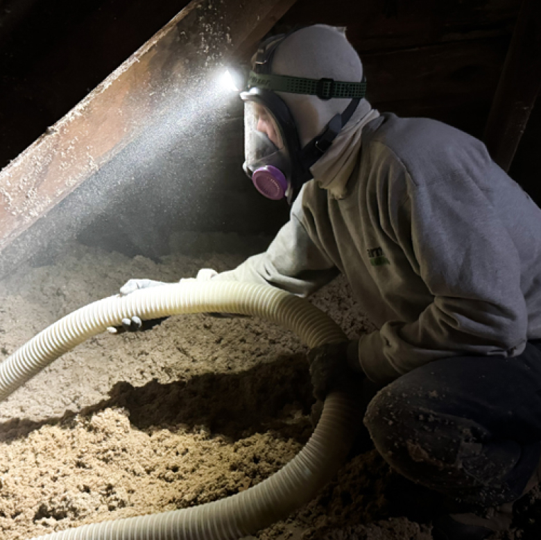 Cellulose blown-in insulation being installed in a Vermont home, providing energy-efficient insulation.