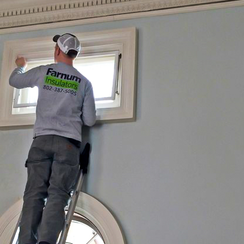 Indow window interior installation process with a technician fitting the window inserts