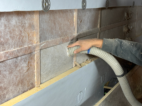 Basement dense packed cellulose installation, providing efficient insulation.
