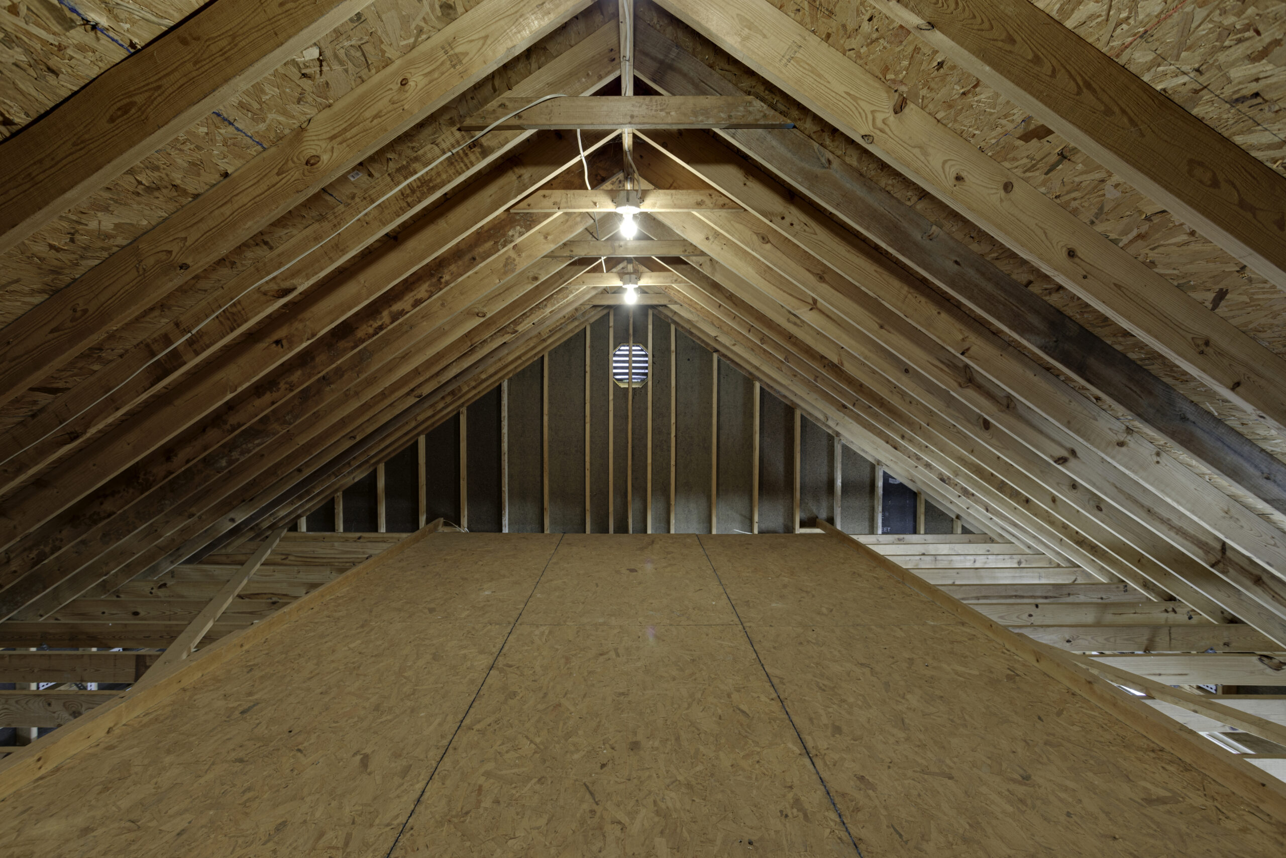 Unfinished Attic Space With Exposed Wooden Beams.